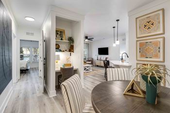 a renovated living room and dining room with a table and chairs